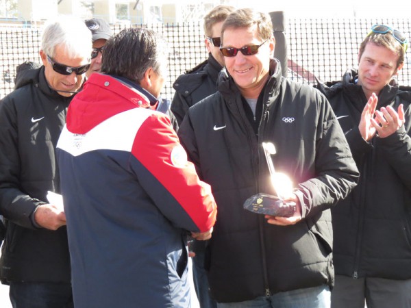 IOC Evaluation Commission Chief Alexander Zhukov receives souvenir at iconic Madeu ice rink in Almaty (GamesBids Photo)