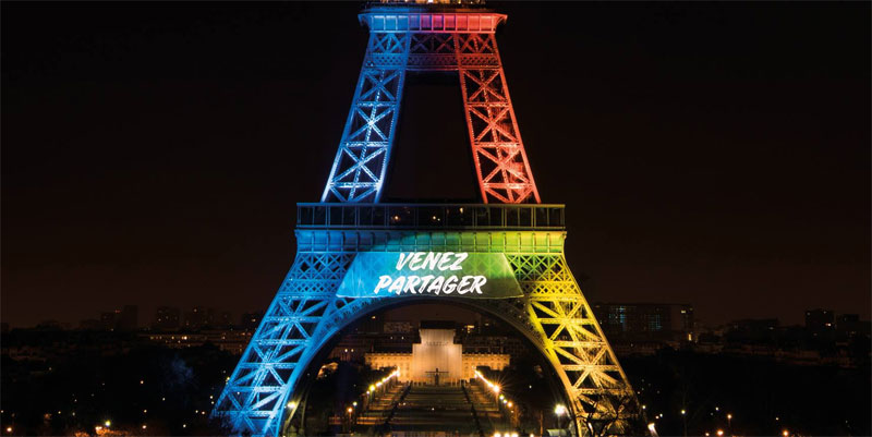 Paris 2024 strapline "Made for Sharing" projected on Eiffel Tower in French (Paris 2024 Photo)
