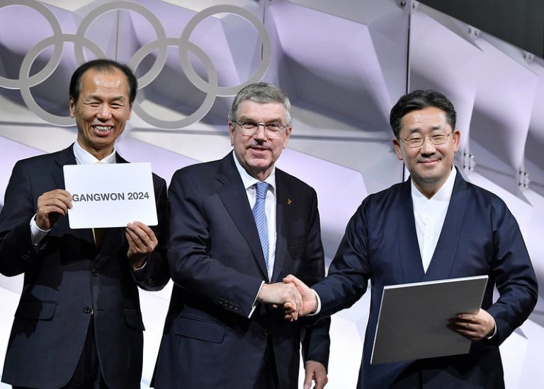 IOC President Thomas Bach (centre) with Gangwon Governor Choi Moon-soon (left) shortly after Gangwon 2024 awarded Winter Youth Olympics by 79-2 vote (Photo: Christophe Moratal/IOC)
